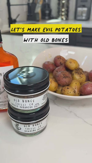 Smoked Jalapeno Salt 100g jars with potatoes, hot sauce, promoting Old Bones Chilli Co's spicy seasonings.